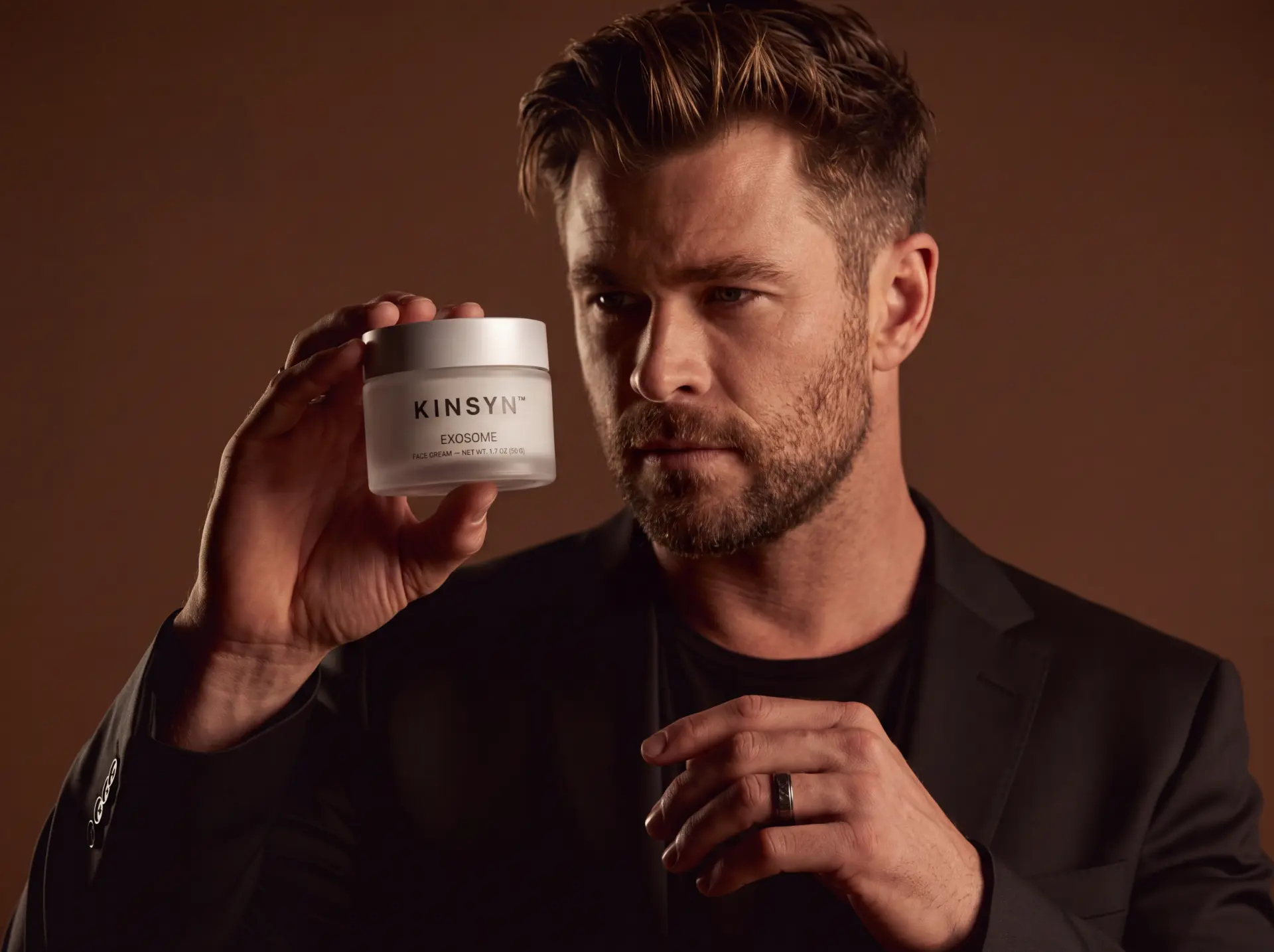 Man holding a jar of KINSYN Exosome face cream